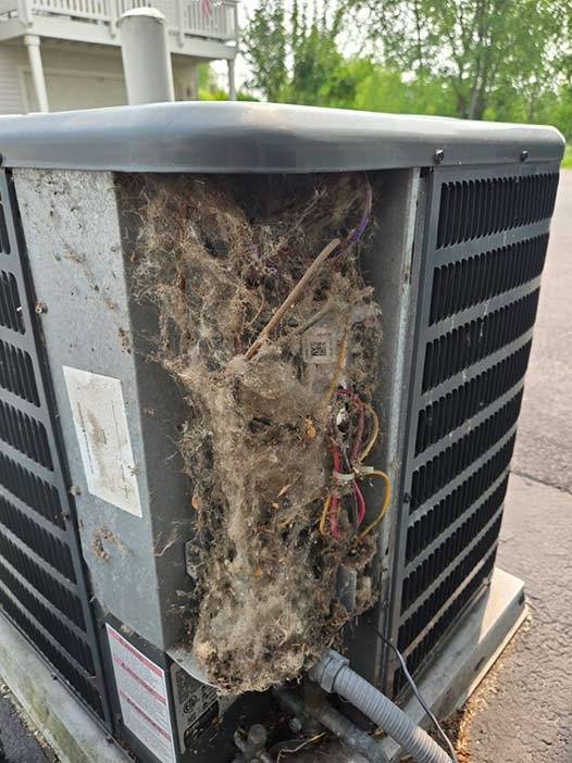 ac-needing-repairs An air conditioner unit outside a house in need of repair